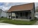 Charming bungalow-style home featuring a covered front porch, well-maintained lawn, and neutral siding at 518 N Grant St, Lebanon, IN 46052