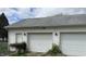 A detached white garage with two garage doors and a side entry, surrounded by greenery at 518 N Grant St, Lebanon, IN 46052
