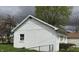 A detached white garage with two garage doors and a side entry, surrounded by greenery at 518 N Grant St, Lebanon, IN 46052