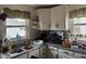Kitchen boasts white cabinets, double sink, granite countertops, and ample natural light from a window at 518 N Grant St, Lebanon, IN 46052