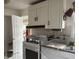 Bright kitchen features white cabinetry, tile backsplash, and modern appliances, creating a functional cooking space at 518 N Grant St, Lebanon, IN 46052