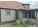 The rear of the home has an enclosed porch, vinyl siding, and a well-maintained lawn at 518 N Grant St, Lebanon, IN 46052