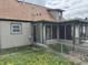 Home has an enclosed porch, vinyl siding, a well-maintained lawn, and a chain link fence at 518 N Grant St, Lebanon, IN 46052