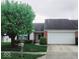 Charming single-story home featuring a brick facade, well-manicured lawn, and attached two-car garage at 5341 Spring Creek Ct, Indianapolis, IN 46254