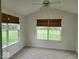 Sunroom featuring two windows with woven shades overlooking the backyard at 5341 Spring Creek Ct, Indianapolis, IN 46254