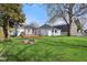 Spacious backyard with a pergola-covered patio and a fire pit at 540 S Broadway St, Atlanta, IN 46031