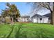 Large backyard featuring a covered patio, fire pit, and mature trees at 540 S Broadway St, Atlanta, IN 46031