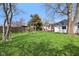 Spacious backyard featuring a well-maintained lawn, deck, gazebo and mature trees offering shade at 540 S Broadway St, Atlanta, IN 46031