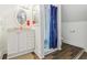Bathroom with a vanity, walk-in shower with a stylish blue curtain, and tile flooring at 540 S Broadway St, Atlanta, IN 46031