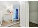 Bright bathroom featuring a vanity, walk-in shower with blue curtain, and storage at 540 S Broadway St, Atlanta, IN 46031