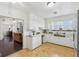 Bright kitchen with white cabinetry and an open view to the living room at 540 S Broadway St, Atlanta, IN 46031