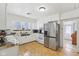 Well-lit kitchen with modern stainless steel refrigerator and white cabinetry at 540 S Broadway St, Atlanta, IN 46031