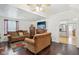 Inviting living room with hardwood floors, a fireplace, and comfortable seating arrangements at 540 S Broadway St, Atlanta, IN 46031