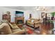 Cozy living room with a fireplace, hardwood floors, and comfortable couches at 540 S Broadway St, Atlanta, IN 46031
