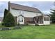 Spacious backyard featuring a covered porch, a deck, and lush green lawn at 5573 Royal Troon Way, Avon, IN 46123