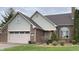 Charming brick home with a two-car garage, arched window, and well-maintained lawn at 5573 Royal Troon Way, Avon, IN 46123