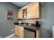 Basement kitchenette featuring sink, mini-fridge, and overhead cabinets at 5624 Ottawa Pass, Carmel, IN 46033
