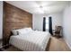 Comfortable bedroom with wooden accent wall, ceiling fan, and rocking chair at 5624 Ottawa Pass, Carmel, IN 46033