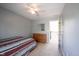 Well-lit bedroom featuring a ceiling fan and a view of the stairway and landing at 5624 Ottawa Pass, Carmel, IN 46033