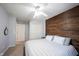 Spacious bedroom with ceiling fan, wooden accent wall, and ample storage at 5624 Ottawa Pass, Carmel, IN 46033