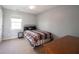 Bedroom with neutral colored walls, ceiling fan, and large window at 5624 Ottawa Pass, Carmel, IN 46033