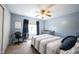 Bright bedroom with desk, crib, ceiling fan, and a window with natural light at 5624 Ottawa Pass, Carmel, IN 46033