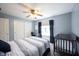 Bedroom with desk, crib, ceiling fan, and large closet at 5624 Ottawa Pass, Carmel, IN 46033