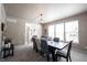 Dining room with large window, modern lighting, and doorway to foyer and staircase at 5624 Ottawa Pass, Carmel, IN 46033