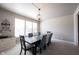 Bright dining room with a dark wood table, seating for six and a view of the front yard at 5624 Ottawa Pass, Carmel, IN 46033