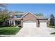 Traditional brick home featuring a three-car garage and well-maintained landscaping at 5624 Ottawa Pass, Carmel, IN 46033