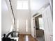 Bright foyer with hardwood floors, staircase, and view into an adjacent room at 5624 Ottawa Pass, Carmel, IN 46033