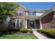 Charming brick home entrance with manicured bushes and classic architectural details at 5624 Ottawa Pass, Carmel, IN 46033