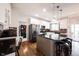 Gourmet kitchen with granite counters, island seating, stainless appliances, and white cabinetry at 5624 Ottawa Pass, Carmel, IN 46033