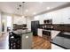 Modern kitchen with stainless steel appliances, granite countertops, and hardwood floors at 5624 Ottawa Pass, Carmel, IN 46033