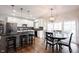 Open-concept kitchen with granite counters, island, and a view into the dining area at 5624 Ottawa Pass, Carmel, IN 46033