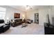 Spacious living room with plush carpeting, comfortable seating, and a decorative bookshelf at 5624 Ottawa Pass, Carmel, IN 46033