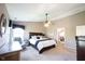 Comfortable main bedroom featuring a dresser, ceiling fan and ensuite bath at 5624 Ottawa Pass, Carmel, IN 46033