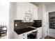 Desk nook features granite counters, upper cabinets, and stone accent backsplash at 5624 Ottawa Pass, Carmel, IN 46033