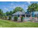 Community pool is secured by a black fence and surrounded by landscaping and seating at 5624 Ottawa Pass, Carmel, IN 46033