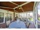 Comfortable screened-in porch with ample seating and views of the backyard at 5624 Ottawa Pass, Carmel, IN 46033