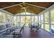 Screened-in porch with ample seating, ceiling fan, and wood flooring at 5624 Ottawa Pass, Carmel, IN 46033