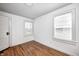 Bright bedroom featuring hardwood floors, two windows, and neutral walls and trim at 5933 Guilford Ave, Indianapolis, IN 46220