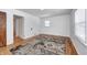 Bedroom with hardwood flooring and neutral color area rug, white walls, and natural light from the window at 5933 Guilford Ave, Indianapolis, IN 46220