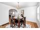 Elegant dining room with hardwood floors, chandelier, arched doorway, and seating for four at 5933 Guilford Ave, Indianapolis, IN 46220