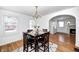 Bright dining room with hardwood floors, a chandelier, and seating for four near arched doorway at 5933 Guilford Ave, Indianapolis, IN 46220