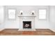 Elegant marble fireplace with decorative sconces and beautiful hardwood floors in the living room at 5933 Guilford Ave, Indianapolis, IN 46220