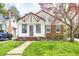 Charming home with a well-manicured lawn, brick accents, and beautiful blossoming tree at 5933 Guilford Ave, Indianapolis, IN 46220