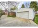 Side view of property with detached garage, a large drive way and lawn at 5933 Guilford Ave, Indianapolis, IN 46220