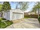 Spacious detached garage with an expansive concrete driveway and a well-maintained yard at 5933 Guilford Ave, Indianapolis, IN 46220