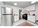 Bright kitchen featuring white cabinets, a stainless steel gas range and oven and a decorative area rug at 5933 Guilford Ave, Indianapolis, IN 46220